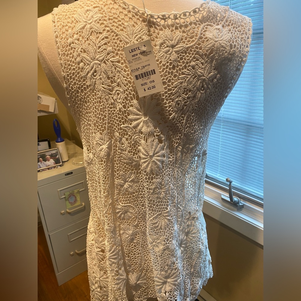 Lacey open top.  Perfect over a tank.  Would look great with a bathing suit too
